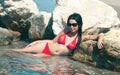 Women in red bikini and sunglasses in the sea Royalty Free Stock Photo