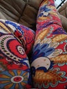 Women in red colorful leggings lounging on a brown couch