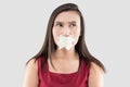 Women in red dresses use masking tape to close the mouth because they do not want to comment.