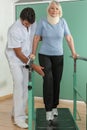 Women rehabilitating her legs with his doctor