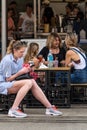 Women relax with a drink at farmers market, Sidney Australia.