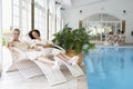 Women Relaxing Around Pool At Spa