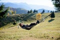 Women relaxing in hammock in autumn. mountain view