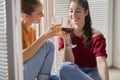 Women relaxing next to the balcony window