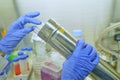 The women researcher using seropipette and cell culture flask do the aseptic technique for changing the medium of adherent cell Royalty Free Stock Photo