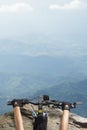 Women riding on a bicycle handlebar top of a mountain view Royalty Free Stock Photo