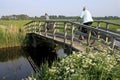 Women riding bike in polder landscape