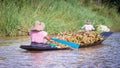 Women rowing a dugout canoe in Inle Lake, Myanmar.