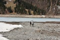 Women with rucksack and boy walking on dry bottom of KlÃÂ¶ntalersee lake Royalty Free Stock Photo