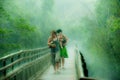 Women running in intensive rain, driving rain in rainforest near by Iguazu Falls, Brazil