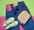 Women's accessories lie on classic jeans with an overstated wais