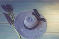 Women`s accessories view from above. Conceptual image. Female hat and lupine flowers on a wooden background. Royalty Free Stock Photo