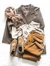 Women`s autumn cozy clothes - corduroy trousers, plaid jacket, turtleneck, suede boots and cashmere scarf on a light background, Royalty Free Stock Photo