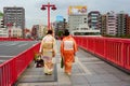 Women`s back in japanese traditional kimonos walking at bridge over the Sumida River