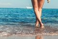 Women`s beautiful sexy legs on the beach