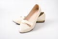 women`s beige ballet flats on a white background.