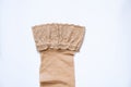 Women`s beige nylon stockings on a white background close up Royalty Free Stock Photo