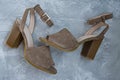 Women`s beige sandals. Summer footwear. Light background. Background under the concrete Royalty Free Stock Photo
