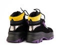 Women's black, purple and yellow hiking boots isolated white background. Back side view. Fashion shoes. Photoshoot Royalty Free Stock Photo