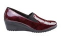 Women`s burgundy patent leather shoes, high-soled, on a white background Royalty Free Stock Photo