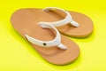 Women`s Causal Braided natural color Beach Day Flip Flops isolated on bright yellow