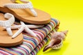 Women`s Causal natural color Beach Flip Flops and Colorful Striped Beach Towel decorated with White Finger Starfish and Seashells