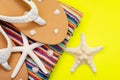 Women`s Causal natural color Beach Flip Flops and Colorful Striped Beach Towel decorated with White Finger Starfish and Seashells