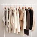 Women's clothes capsule wardrobe in pastel colors. Knitted jumpers and cardigans for spring autumn season on hanger