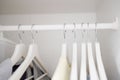 Women clothes hanging on wooden hangers in the closet. Fashionable casual clothes. Shopping.