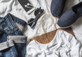 Women`s clothing buy concept. Jeans, sneakers, phone, sunglasses, paper bag on a light background Royalty Free Stock Photo