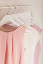 Women`s clothing in pink tones on a white hanger. Royalty Free Stock Photo