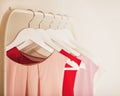 Women`s clothing in pink tones on a white hanger. Royalty Free Stock Photo