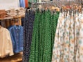 Women& x27;s clothing store. Skirts and dresses with floral print hang on hangers. Royalty Free Stock Photo