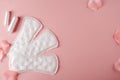 Women`s cycle hyhienic pads and tampons on pink background. Copy space Royalty Free Stock Photo