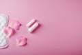 Women`s cycle hyhienic pads and tampons on pink background. Copy space Royalty Free Stock Photo