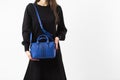 Women& x27;s dark blue leather bag in vintage style, black lock, front view. The trendy purse office, business trips or Royalty Free Stock Photo