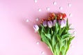 Tulip flowers and small hearts on soft pink background Royalty Free Stock Photo