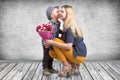 Small son gives his beloved mother a beautiful bouquet of pink roses and kisses mum on the cheek . Spring,Women`s day,mother`s day Royalty Free Stock Photo