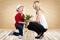 Stylish son gives his beloved mother a bouquet of beautiful tulips. Spring, concept of family vacation. Women`s day. Royalty Free Stock Photo