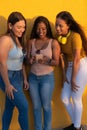 Women`s Diversity, Girl Power, Femininity Concept. Group Of Three Happy Young Women Holding Cellular Royalty Free Stock Photo