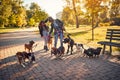 Women`s enjoying with dogs while walking outdoors