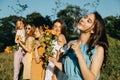 Women`s Equality Day, Girl power, diversity, femininity concept. Group of five happy young women holding Roses flowers on nature Royalty Free Stock Photo
