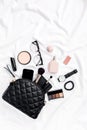 Women`s fashion. Black handbag, makeup brushes, cosmetics, sunglasses, accessories on white background. social media