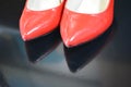 A very bright pair of shoes, fashionable and stylish women`s red shoes with a pointed toe and high heels. Royalty Free Stock Photo