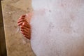 Women`s feet covered with foam after massage in the Turkish bath Royalty Free Stock Photo