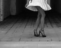 Women`s feet in heels in a dark alley of the city Royalty Free Stock Photo