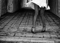 Women`s feet in heels in a dark alley of the city Royalty Free Stock Photo