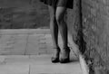 Women`s feet in heels in a dark alley of the city Royalty Free Stock Photo