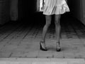 Women`s feet in heels in a dark alley of the city Royalty Free Stock Photo