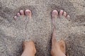 Women`s feet without manicure in the pebbles on the beach. The concept of vacation Royalty Free Stock Photo